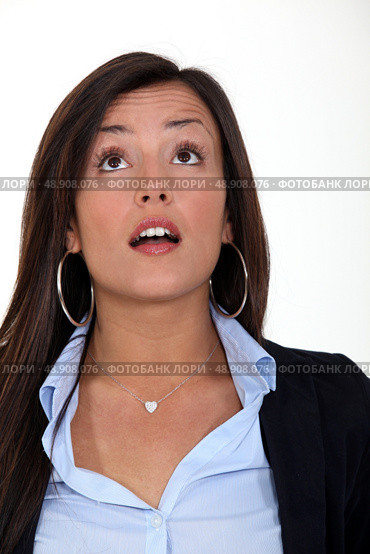 A surprised woman looking up at something. Стоковое фото, агентство Ingram Publishing / Фотобанк Лори