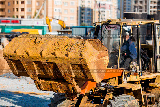 A tractor on a construction site in close-up. Heavy machinery for construction and landscape design. Стоковое фото, фотограф Photojuli / Фотобанк Лори