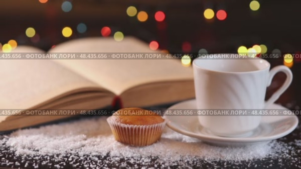 A white cup and saucer and a small muffin, Стоковое видео, видеограф Zakharova Natasha / Фотобанк Лори