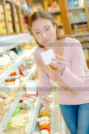 a woman is buying yogurts. Стоковое фото, агентство Ingram Publishing / Фотобанк Лори