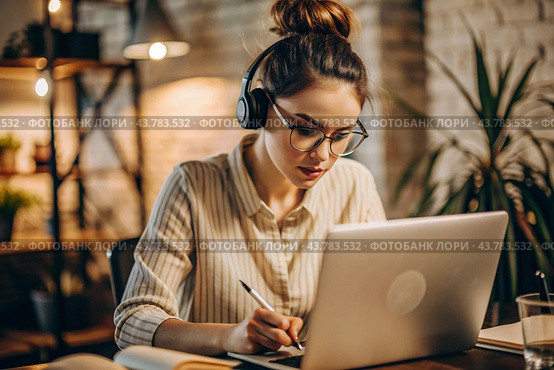 A young female freelance businessman in glasses and headphones is working on a laptop or shopping in an online store. The woman is writing something in a notebook. Стоковое AI-изображение, AI-художник Photojuli / Фотобанк Лори
