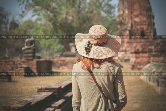 A young woman is exploring the ancient ruins of a buddhist temple city. Стоковое фото, агентство Ingram Publishing / Фотобанк Лори