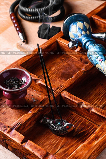 Accessories for Shisha. Dismantled parts of hookah on wooden background . Стоковое фото, агентство Ingram Publishing / Фотобанк Лори