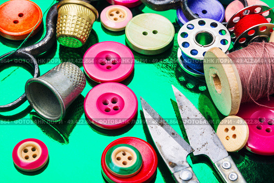 Accessories for tailoring.Bright assorted sewing buttons in mix colors. Set of tailoring accessories. Стоковое фото, агентство Ingram Publishing / Фотобанк Лори