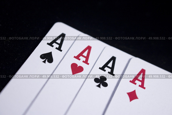 ace four of a kind poker card on dark black background. Стоковое фото, агентство Ingram Publishing / Фотобанк Лори