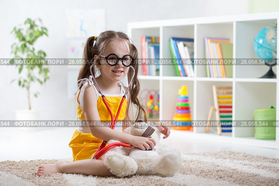Adorable child playing doctor in daycare. Стоковое фото, фотограф Оксана Кузьмина / Фотобанк Лори