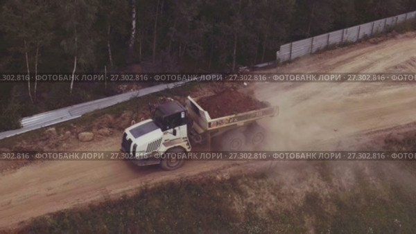 Aerial view driving dump truck. Стоковое видео, видеограф Илья Насакин / Фотобанк Лори