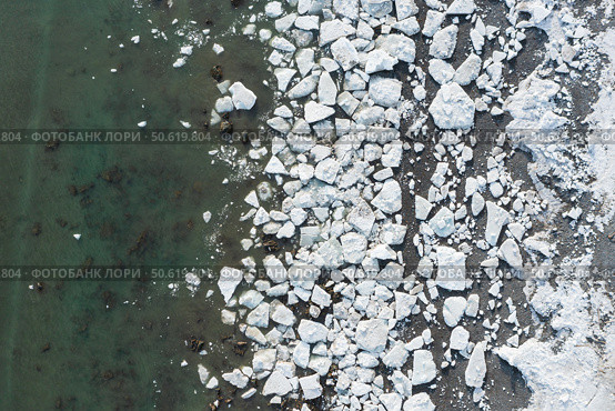 Aerial view of melting ice on the sea coast. Top view of white ice floes on the shore and in sea water. Changing of the climate. Northern nature. Spring season in the Far North. Natural background. Стоковое фото, фотограф Андрей Степанов / Фотобанк Лори