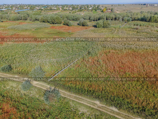 Aerial view on wooden footbridge through the reeds over flood-meadow. Kartal Eco Park, Orlovka village, Reni raion, Odessa oblast, Ukraine, Eastern Europe (2020 год). Стоковое фото, фотограф Некрасов Андрей / Фотобанк Лори