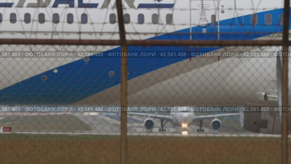 Airplane behind the airport fence, close-up (2023 год). Редакционное видео, видеограф Игорь Жоров / Фотобанк Лори