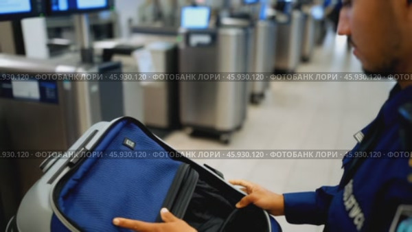 Airport Security Officer Inspecting Luggage at Checkpoint. Стоковое видео, видеограф Данил Руденко / Фотобанк Лори
