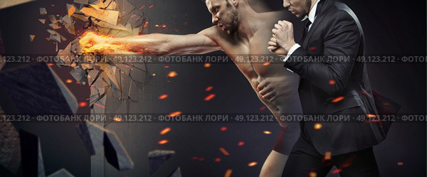 Ambitious businessman smashing a barrier. Стоковое фото, агентство Ingram Publishing / Фотобанк Лори
