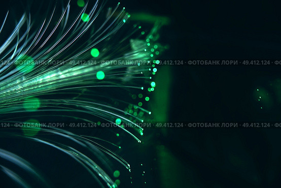 An amazing and vibrant macro of green fiber optical pipes that illuminate making sparkles and glitters with black background. Стоковое фото, агентство Ingram Publishing / Фотобанк Лори