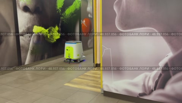 An autonomous cleaning robot moving across the shiny floor of the Vkusno i Tochka restaurant, emphasizing its modern technologies, Vkusno i tochka, Russia, Moscow, 05.05.2025. Стоковое видео, видеограф Терехова Марина / Фотобанк Лори