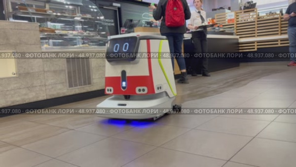 An autonomous cleaning robot moving across the shiny floor of the Vkusno i Tochka restaurant, emphasizing its modern technologies, Vkusno i tochka, Russia, Moscow, 05.05.2025. Редакционное видео, видеограф Терехова Марина / Фотобанк Лори