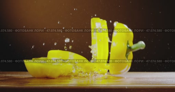 An Elegant Wooden Surface Captured with Dramatic yellow pepper drops on wooden surface. Стоковое видео, видеограф Владимир Ковальчук / Фотобанк Лори