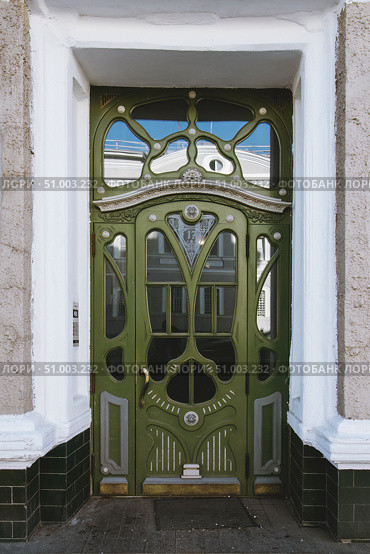 Antique green wooden door with carved decorations and glasses. Стоковое фото, фотограф Константин Григорьев / Фотобанк Лори