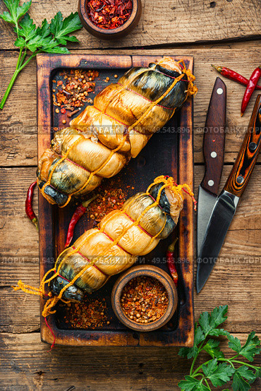 Appetizing fish roll made from smoked mackerel on wooden table. Smoked fish roll. Стоковое фото, агентство Ingram Publishing / Фотобанк Лори