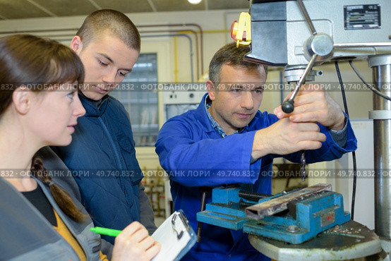 apprentices working on the machine - metal processing. Стоковое фото, агентство Ingram Publishing / Фотобанк Лори