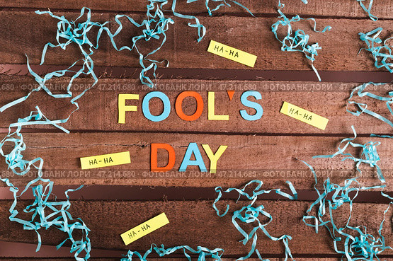 April Fools Day made of colored letters, funny notes and paper on wooden background. Стоковое фото, фотограф Елена Руй / Фотобанк Лори