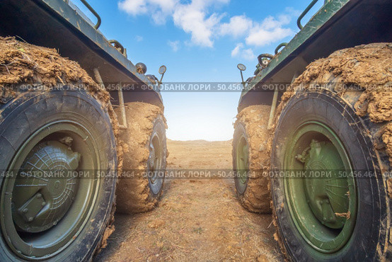 Armored personnel carrier wheels in the mud at field. Стоковое фото, агентство Ingram Publishing / Фотобанк Лори