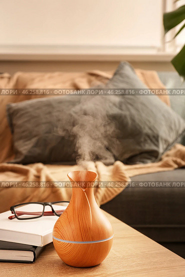 Aroma oil diffuser on table in room. Стоковое фото, фотограф Pixel_shot / Фотобанк Лори
