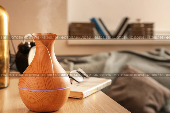 Aroma oil diffuser on table in room. Стоковое фото, фотограф Pixel_shot / Фотобанк Лори