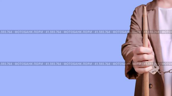 Arrested woman teacher handcuffed on a blue background, banner copy space. Стоковое фото, фотограф Андрей Журавлев / Фотобанк Лори