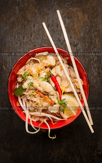 Asian noodles with chopstick, chicken and sprouts on dark wooden background, top view. Стоковое фото, агентство Ingram Publishing / Фотобанк Лори