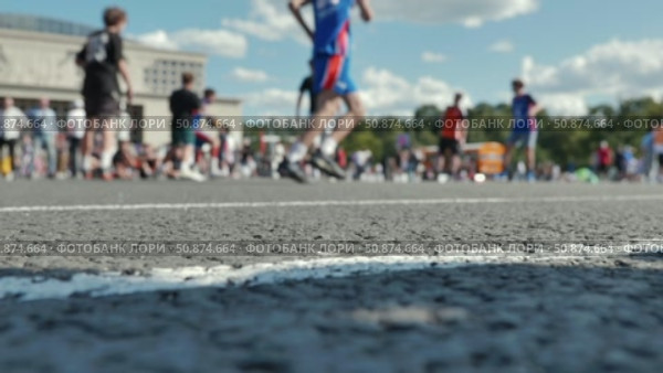 Athletes playing basketball during sports day, focusing on the ground. Стоковое видео, видеограф Mikhail Davidovich / Фотобанк Лори
