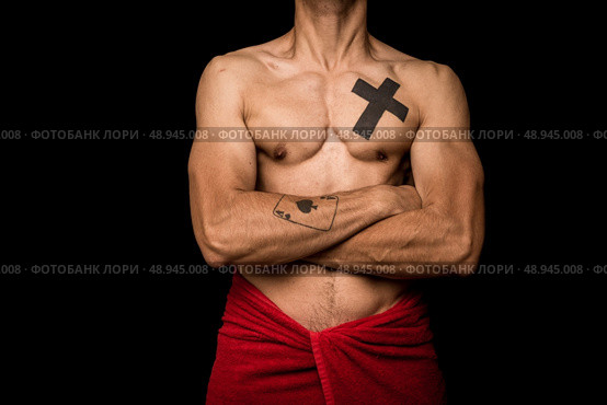 Athletic young man with tattoos and towel around his waist. Стоковое фото, агентство Ingram Publishing / Фотобанк Лори