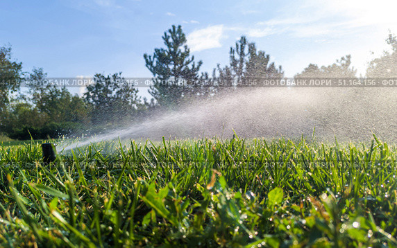 Automatic garden irrigation system watering lawn. Automatic equipment for irrigation and maintenance of lawns, gardening. Стоковое фото, фотограф Владислав Тригуб / Фотобанк Лори