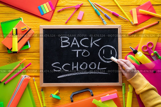 Back to school supplies arrangement vivid colorful neon color and blackboard hand chalk. Стоковое фото, агентство Ingram Publishing / Фотобанк Лори