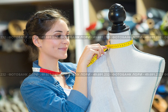 beautiful young woman in measuring dummy with tape. Стоковое фото, агентство Ingram Publishing / Фотобанк Лори