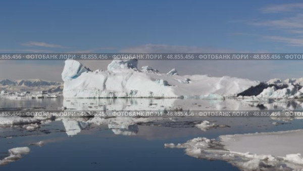 Big Iceberg in Antarctica Winter Scenery, Amazing Shape Ice Formation of Massive Large Enormous Blue Icebergs in Antarctic Peninsula Landscape Seascape with Ocean Sea Water. Стоковое видео, видеограф Vladimir / Фотобанк Лори