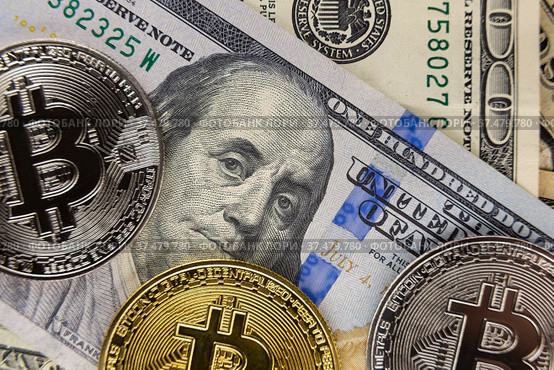 Bitcoin coins lie on dollars. Стоковое фото, фотограф Kozub Vasyl / Фотобанк Лори