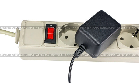 Блок питания в розетке на белом фоне. AC/DC adapter  on white background. Стоковое фото, фотограф Татьяна Д / Фотобанк Лори