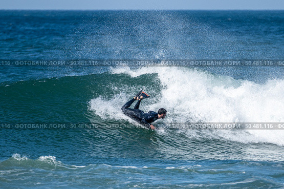 Bodyboarder surfing ocean wave on a sunny winter day. Стоковое фото, агентство Ingram Publishing / Фотобанк Лори