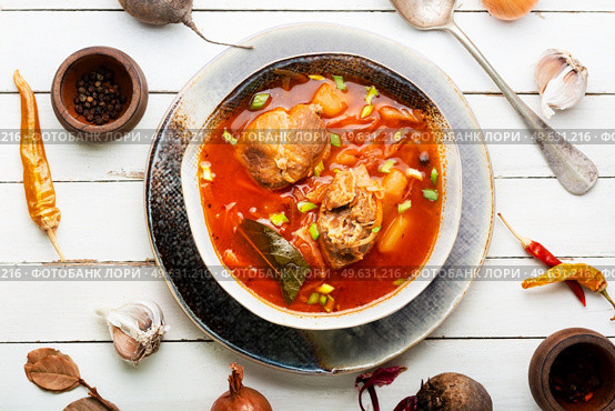 Borscht - hot soup with beets and meat. Red Ukrainian borscht or soup. Red Ukrainian borscht. Стоковое фото, агентство Ingram Publishing / Фотобанк Лори