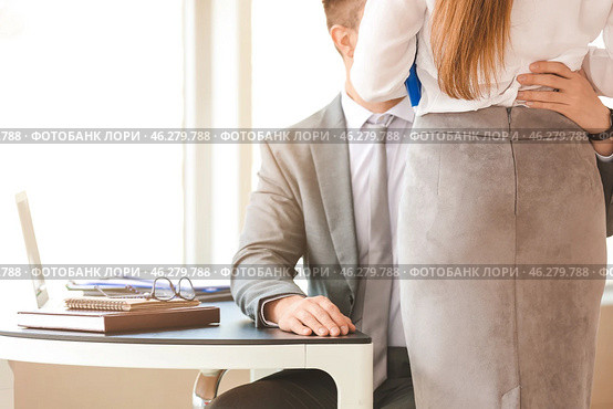 Boss molesting his secretary in office. Стоковое фото, фотограф Pixel_shot / Фотобанк Лори