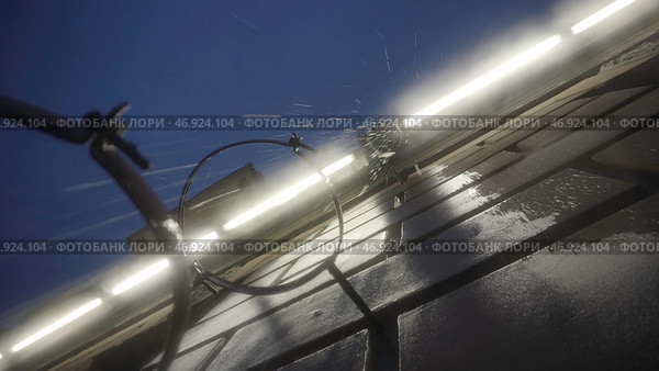 Bottom view of the building wall and a drainpipe during heavy rain on late evenin sky background. Стоковое фото, фотограф David Kashakhi / Фотобанк Лори