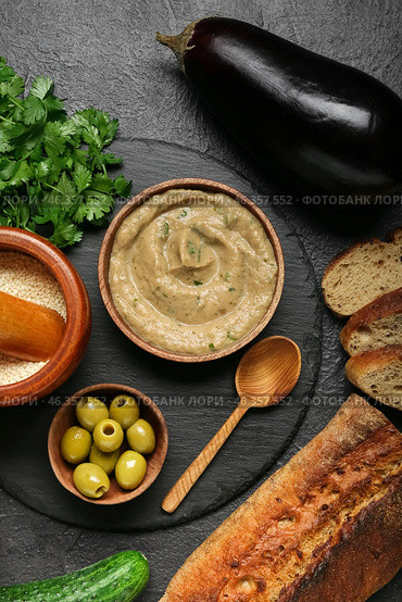 Bowl with tasty baba ghanoush and fresh ingredients on dark background. Стоковое фото, фотограф Pixel_shot / Фотобанк Лори