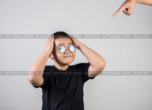 Boy feels sad after the parents scold him. Стоковое фото, агентство Ingram Publishing / Фотобанк Лори