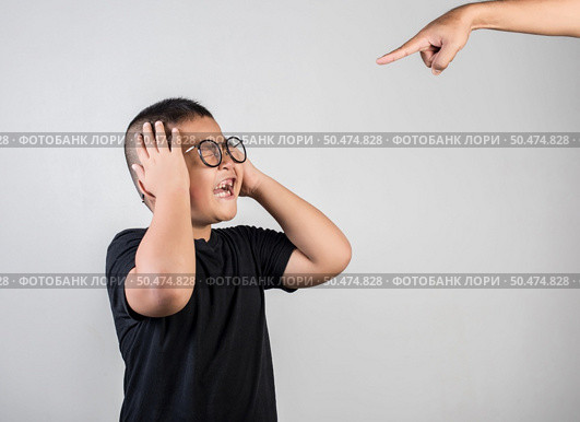 Boy feels sad after the parents scold him. Стоковое фото, агентство Ingram Publishing / Фотобанк Лори