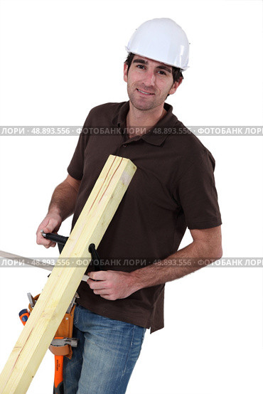 Builder with wood in a vice. Стоковое фото, агентство Ingram Publishing / Фотобанк Лори