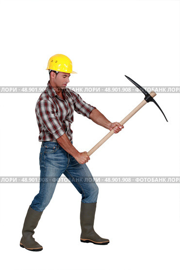 Building worker using a pickaxe, studio shot. Стоковое фото, агентство Ingram Publishing / Фотобанк Лори