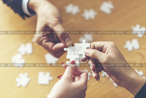 Business solutions, success and strategy concept. Businessman ha. Business solutions, success and strategy concept. Businessman hand connecting jigsaw puzzle.. Business solutions, success and strategy concept. Businessman hand connecting jigsaw puzzle. Стоковое фото, агентство Ingram Publishing / Фотобанк Лори