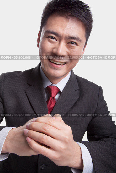 Businessman Bowing Toward Camera. Стоковое фото, агентство Ingram Publishing / Фотобанк Лори