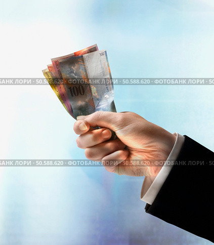 Businessman’s hand holding Swiss Francs. 24316752. Стоковое фото, агентство Ingram Publishing / Фотобанк Лори