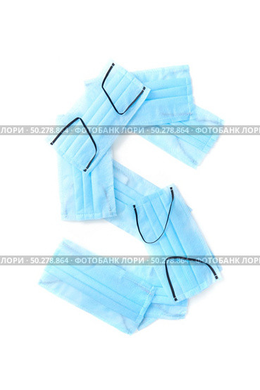 Capital letter S handmade from medical antibacterial protective blue face masks on a white background, copy space. Creative alphabet for making up new words.. Letter S made from protective medical masks on a white background. Стоковое фото, агентство Ingram Publishing / Фотобанк Лори